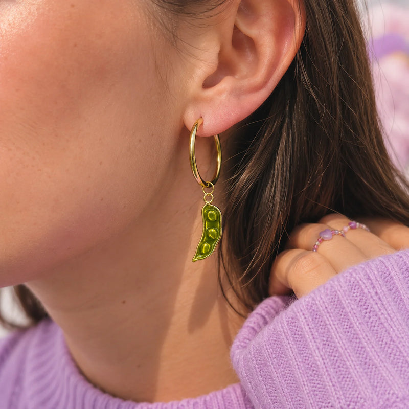 créole dorée avec charm haricot petit pois vert kawaii porté sur une oreille dans un style doux et tendance